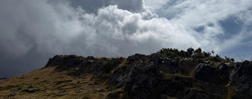 Crook Peak, Somerset Photograph of Crook Peak, Somerset, showing craggy rocks beneath stormy skies